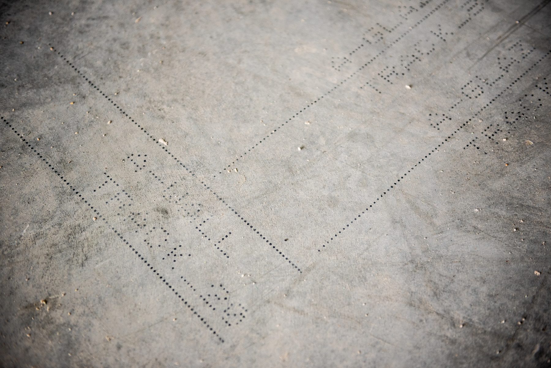 Dot-matrix construction layout printed on concrete by the early Rugged Robotics robot