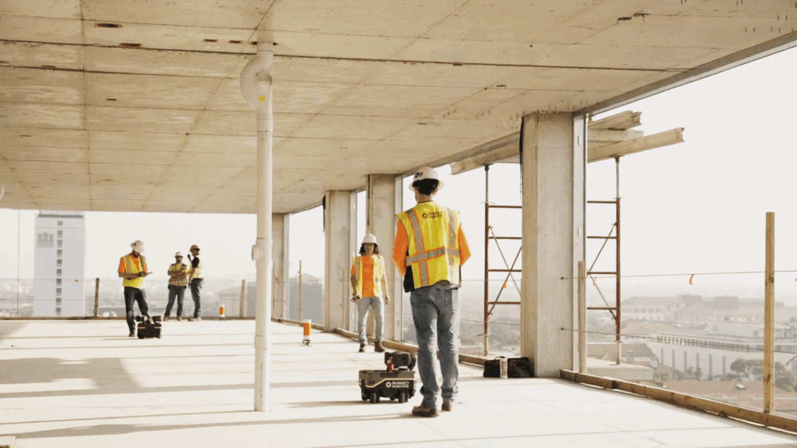 Field crew on a slab with an early Rugged Robotics layout robot